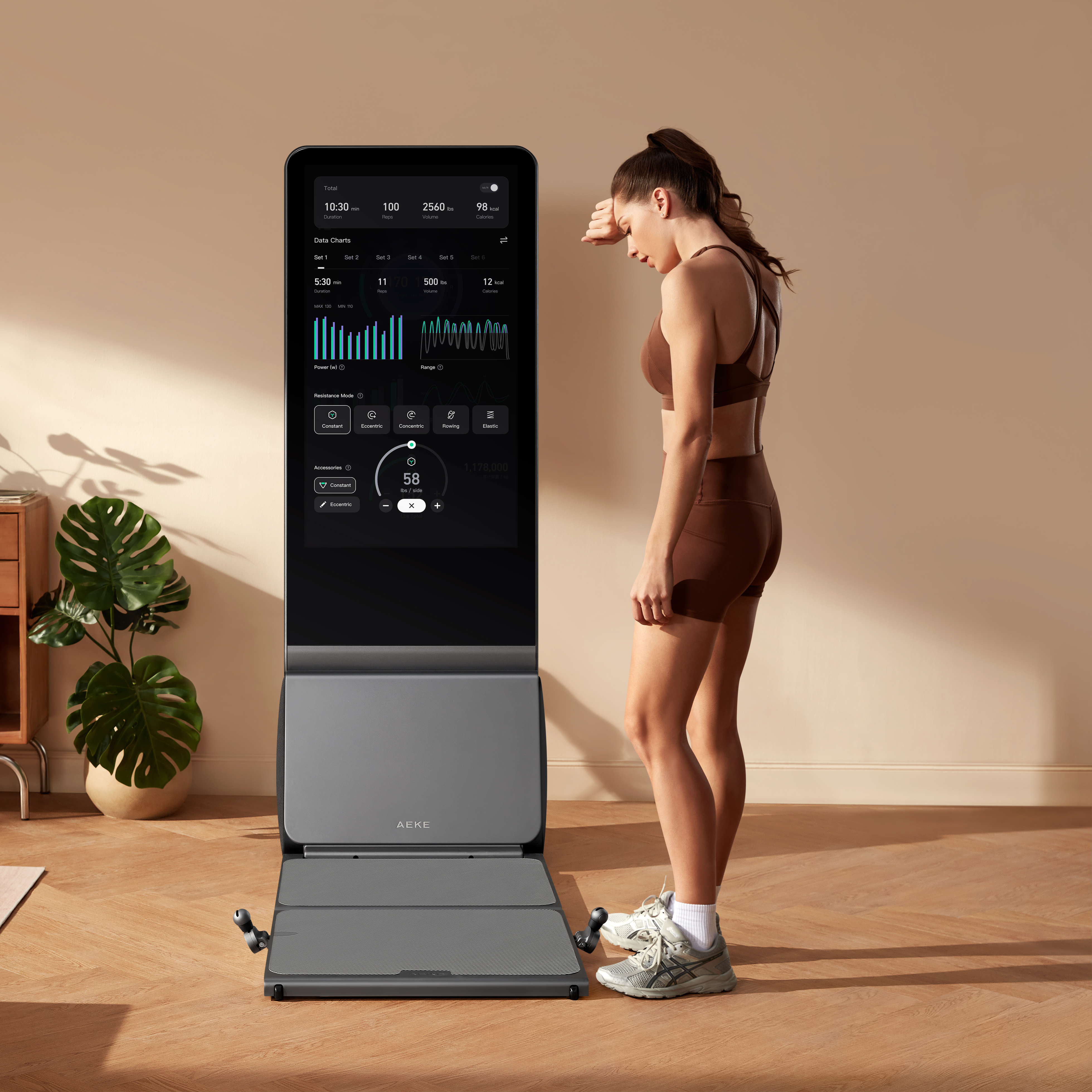 A woman catches her breath while reviewing her comprehensive post-workout health and performance analytics on the AEKE fitness mirror.